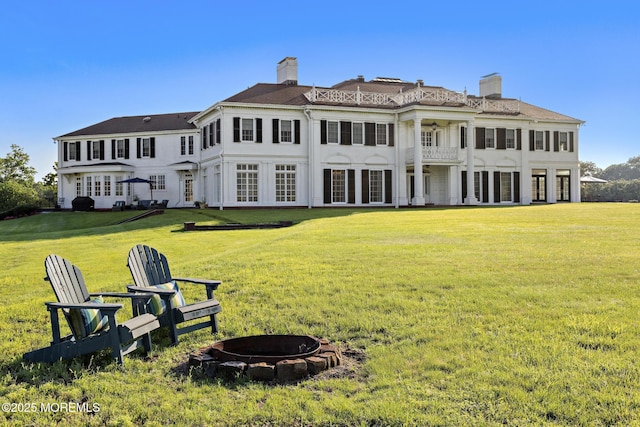 713 Navesink River Rd, Red Bank, NJ 07701 - back of house featuring an outdoor fire pit, a lawn, and a balcony