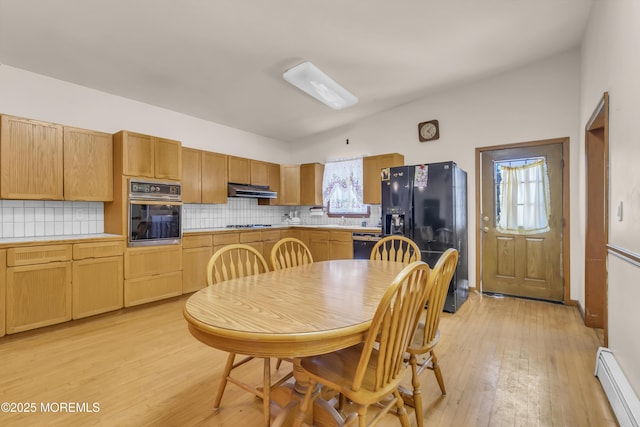 193 Ocean Blvd, Atlantic Highlands, NJ 07716 - kitchen with black appliances, a baseboard heating unit, light wood-style floors, and backsplash