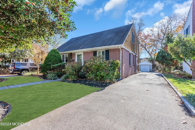 708 New York Blvd, Sea Girt, NJ 08750 - view of front of home featuring driveway, brick siding, an outdoor structure, a detached garage, and a front yard