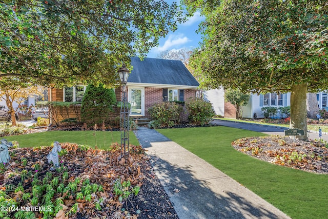 708 New York Blvd, Sea Girt, NJ 08750 - view of front facade with brick siding and a front yard