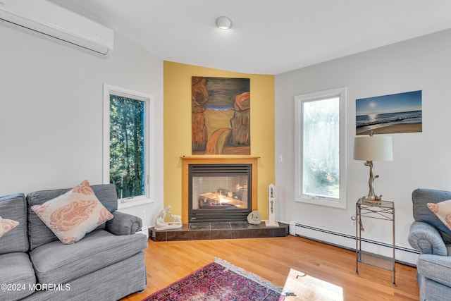 708 New York Blvd, Sea Girt, NJ 08750 - living area featuring an AC wall unit, a baseboard radiator, wood finished floors, a tiled fireplace, and healthy amount of natural light