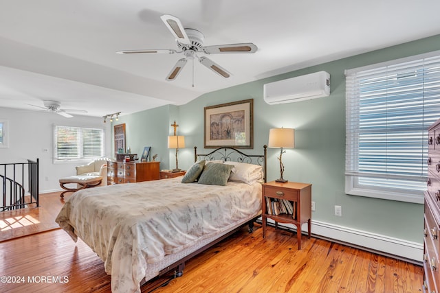 708 New York Blvd, Sea Girt, NJ 08750 - bedroom featuring an AC wall unit, a baseboard radiator, and light wood-style floors