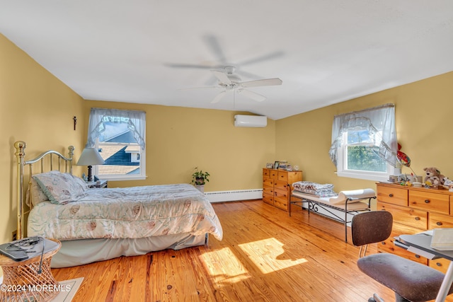 708 New York Blvd, Sea Girt, NJ 08750 - bedroom with baseboard heating, multiple windows, wood finished floors, and a wall mounted air conditioner