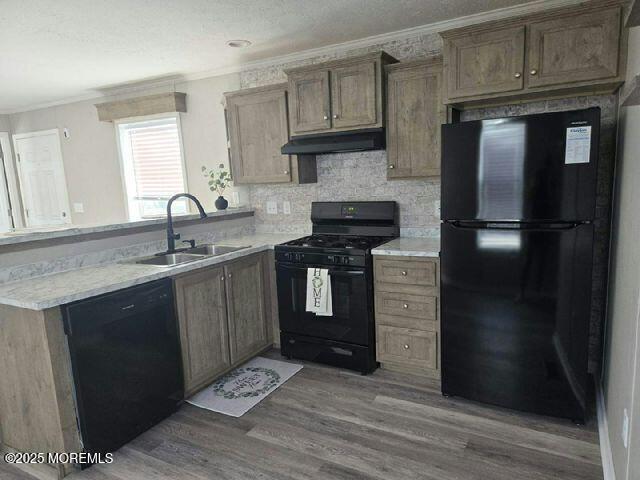 9 Mary Ann Ct, Hazlet, NJ 07734 - kitchen with black appliances, under cabinet range hood, crown molding, wood finished floors, and light countertops