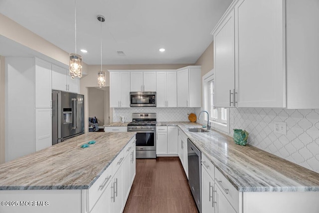10 Willow Ave, Matawan, NJ 07747 - kitchen with stainless steel appliances, a kitchen island, light stone countertops, white cabinetry, and recessed lighting