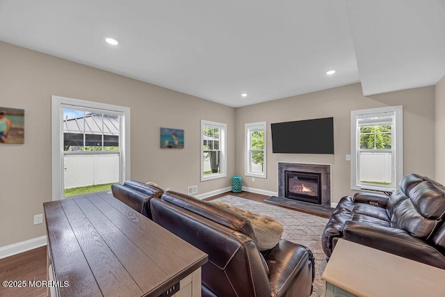 10 Willow Ave, Matawan, NJ 07747 - living area with healthy amount of natural light, a glass covered fireplace, dark wood-style flooring, and recessed lighting
