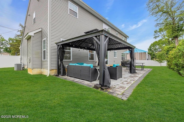 10 Willow Ave, Matawan, NJ 07747 - back of property featuring a gazebo, an outdoor living space, a fenced backyard, and a patio area