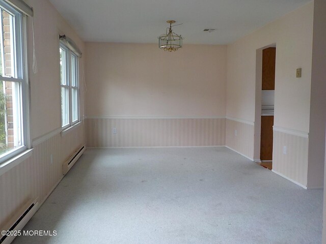 17 Meadowbrook Rd, Brick, NJ 08723 - carpeted spare room with a baseboard heating unit, a baseboard radiator, a wainscoted wall, and a chandelier