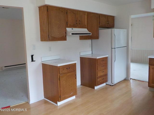 17 Meadowbrook Rd, Brick, NJ 08723 - kitchen featuring exhaust hood, a baseboard heating unit, light wood-style flooring, and brown cabinetry