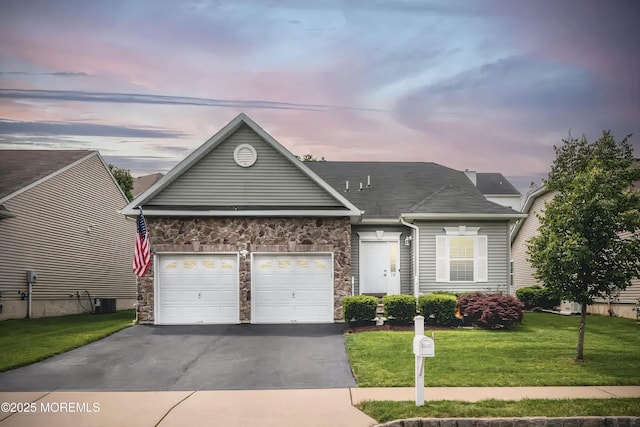 114 Maypink Ln, Howell, NJ 07731 - view of front of house featuring asphalt driveway, stone siding, a garage, and a yard