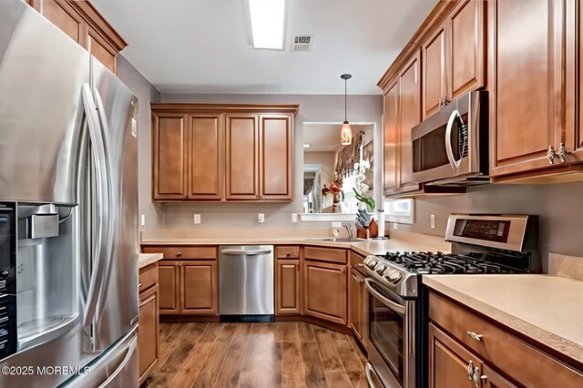 114 Maypink Ln, Howell, NJ 07731 - kitchen with stainless steel appliances, wood finished floors, light countertops, and brown cabinets