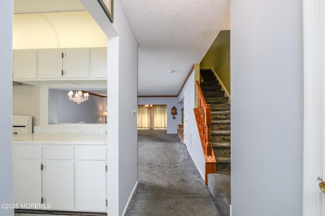 60 Beaumont Ct, Tinton Falls, NJ 07724 - hallway with a chandelier, stairway, dark carpet, and a textured ceiling