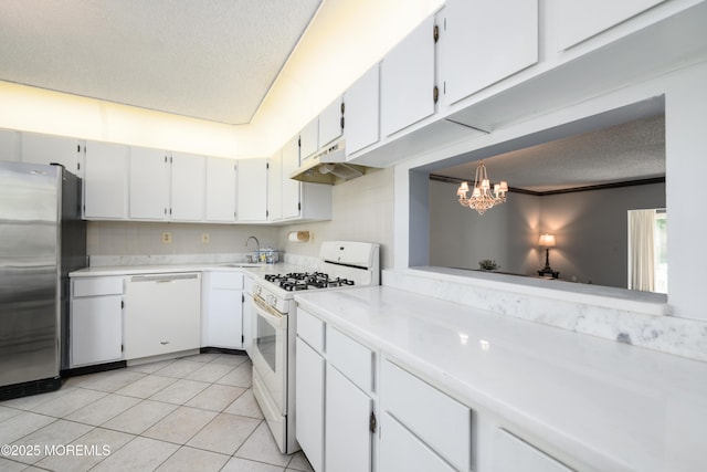 60 Beaumont Ct, Tinton Falls, NJ 07724 - kitchen featuring white appliances, under cabinet range hood, a textured ceiling, light countertops, and light tile patterned flooring