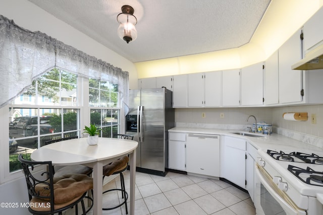 60 Beaumont Ct, Tinton Falls, NJ 07724 - kitchen with white appliances, light countertops, a textured ceiling, light tile patterned floors, and white cabinets
