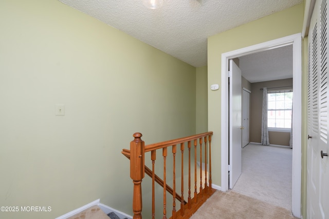 60 Beaumont Ct, Tinton Falls, NJ 07724 - hallway with carpet floors, an upstairs landing, and a textured ceiling