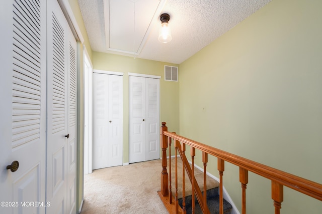 60 Beaumont Ct, Tinton Falls, NJ 07724 - hall featuring attic access, carpet flooring, an upstairs landing, and a textured ceiling