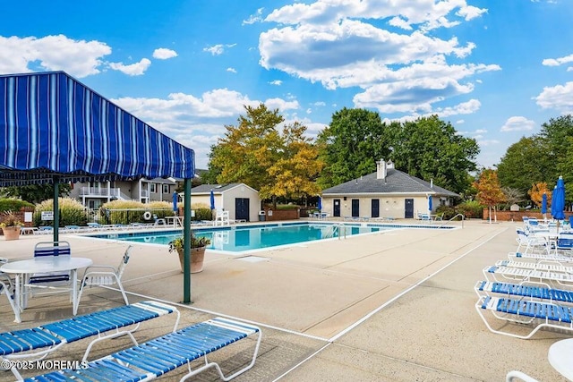 60 Beaumont Ct, Tinton Falls, NJ 07724 - community pool featuring a patio and an outbuilding