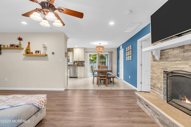 217 Hemlock Dr, Lanoka Harbor, NJ 08734 - living area featuring light wood finished floors, a ceiling fan, a lit fireplace, and recessed lighting