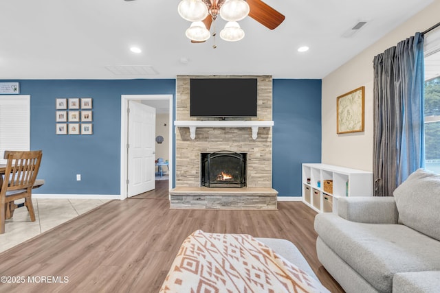 217 Hemlock Dr, Lanoka Harbor, NJ 08734 - living area with a stone fireplace, wood finished floors, recessed lighting, ceiling fan, and a chandelier