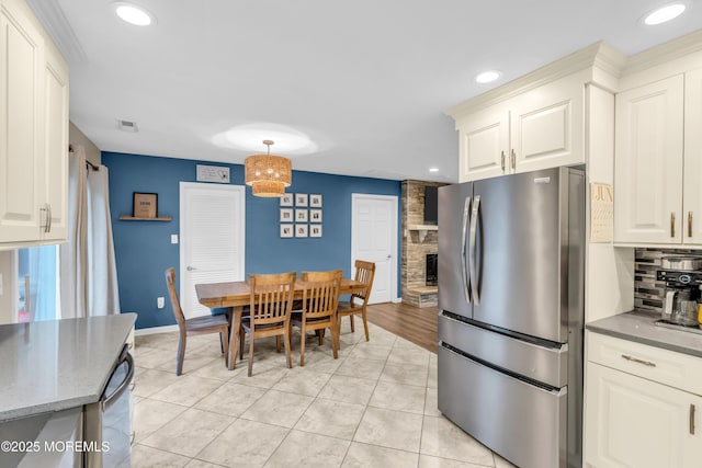 217 Hemlock Dr, Lanoka Harbor, NJ 08734 - kitchen featuring freestanding refrigerator, decorative backsplash, recessed lighting, light stone countertops, and hanging light fixtures