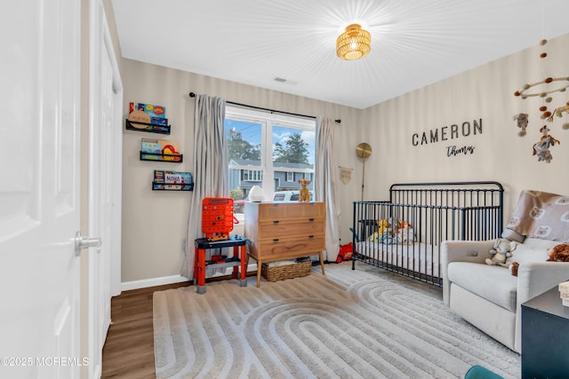 217 Hemlock Dr, Lanoka Harbor, NJ 08734 - bedroom with wood finished floors and a crib