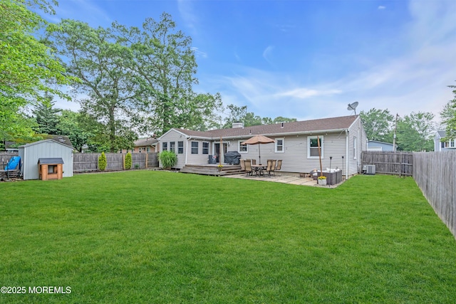 217 Hemlock Dr, Lanoka Harbor, NJ 08734 - rear view of house with a fenced backyard, a storage shed, a wooden deck, a patio area, and a chimney