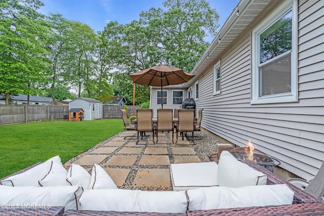 217 Hemlock Dr, Lanoka Harbor, NJ 08734 - fenced backyard featuring an outdoor living space with a fire pit, a storage unit, a patio area, and outdoor dining space