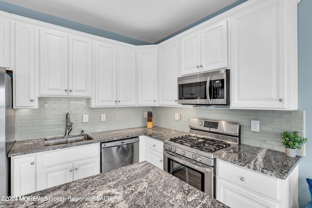 681/2 Shrewsbury Ave, Highlands, NJ 07732 - kitchen with stainless steel appliances, white cabinetry, dark stone counters, and decorative backsplash