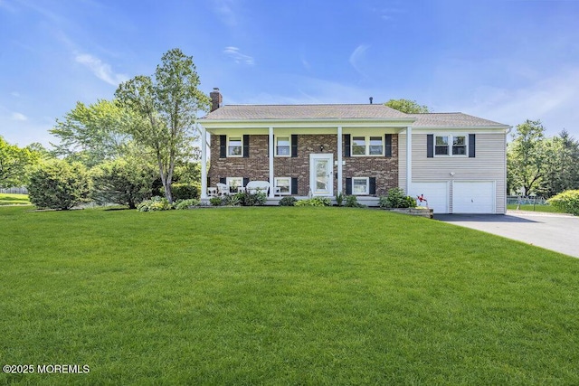 22 Indian Hill Rd, Freehold, NJ 07728 - raised ranch with a chimney, a garage, concrete driveway, and a front yard