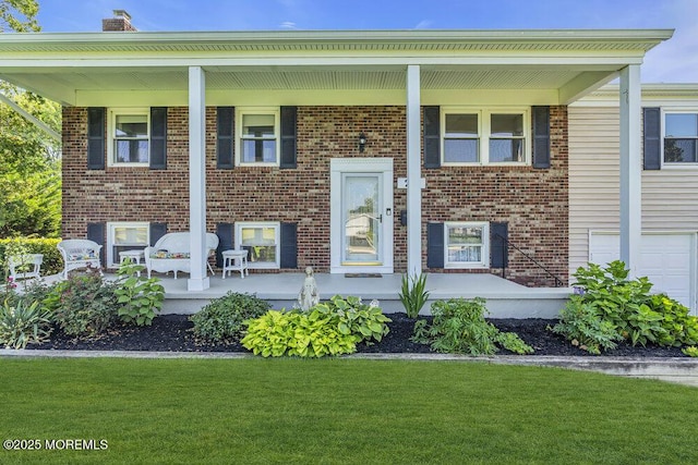22 Indian Hill Rd, Freehold, NJ 07728 - view of front of home featuring covered porch, brick siding, a front lawn, and a chimney