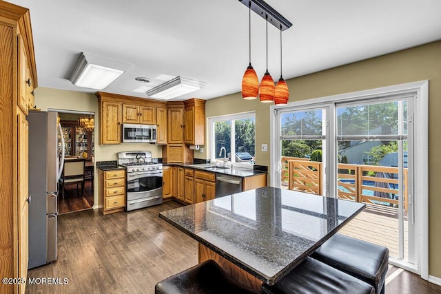 22 Indian Hill Rd, Freehold, NJ 07728 - kitchen with appliances with stainless steel finishes, dark wood-type flooring, decorative light fixtures, and a kitchen bar