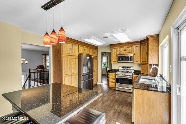 22 Indian Hill Rd, Freehold, NJ 07728 - kitchen with appliances with stainless steel finishes, dark wood-style flooring, plenty of natural light, and dark stone counters