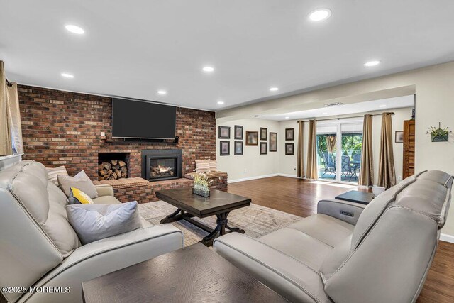 22 Indian Hill Rd, Freehold, NJ 07728 - living area featuring wood finished floors, recessed lighting, a fireplace, and brick wall