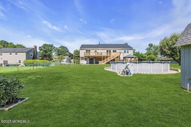22 Indian Hill Rd, Freehold, NJ 07728 - view of grassy yard with stairs, a deck, and an outdoor pool