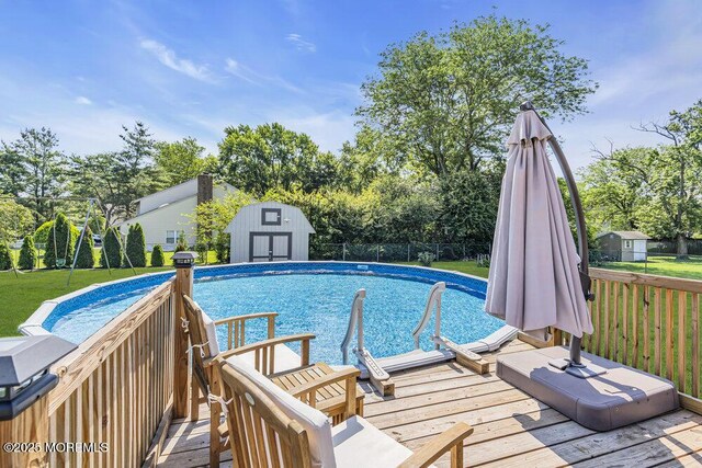 22 Indian Hill Rd, Freehold, NJ 07728 - view of pool with a storage shed, a deck, and view of scattered trees