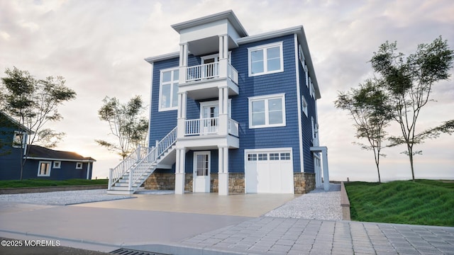370 Kingfisher Rd, Tuckerton, NJ 08087 - view of front facade with a balcony, concrete driveway, stone siding, stairway, and an attached garage