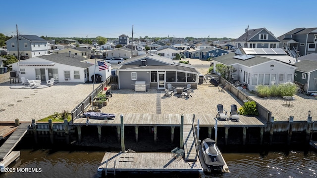 14 S Portland Dr, Little Egg Harbor, NJ 08087 - back of house featuring a residential view, a fenced backyard, a sunroom, a water view, and a patio area