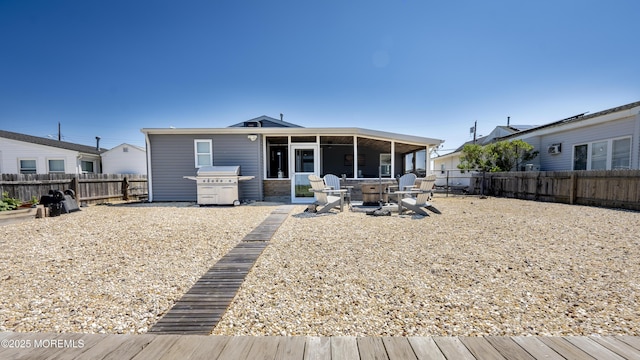14 S Portland Dr, Little Egg Harbor, NJ 08087 - rear view of property with an outdoor fire pit, a fenced backyard, a sunroom, and a patio