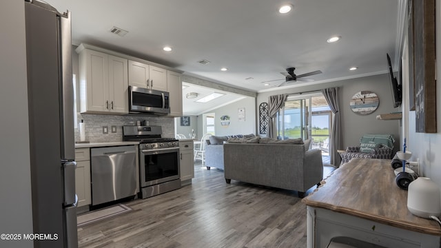 14 S Portland Dr, Little Egg Harbor, NJ 08087 - kitchen with appliances with stainless steel finishes, open floor plan, decorative backsplash, ornamental molding, and a ceiling fan