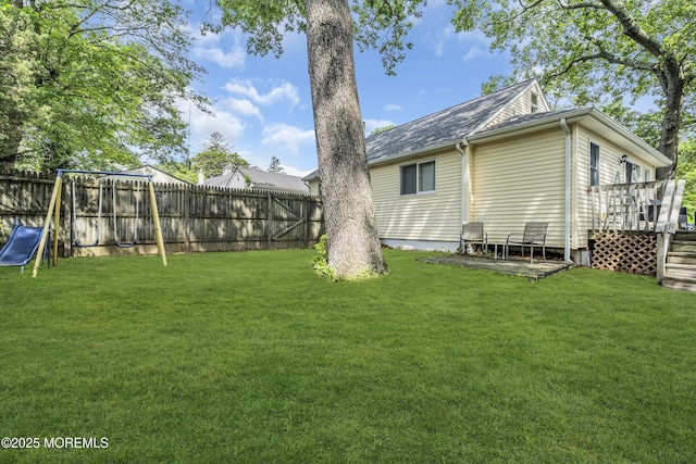 553 Kingfisher Cir, Brick, NJ 08723 - fenced backyard featuring a wooden deck and a playground