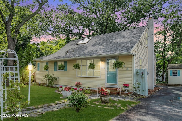 553 Kingfisher Cir, Brick, NJ 08723 - view of front of house featuring a chimney, a front lawn, a shingled roof, and asphalt driveway