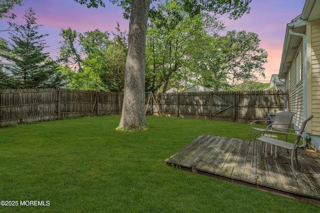 553 Kingfisher Cir, Brick, NJ 08723 - yard at dusk featuring a deck and a fenced backyard