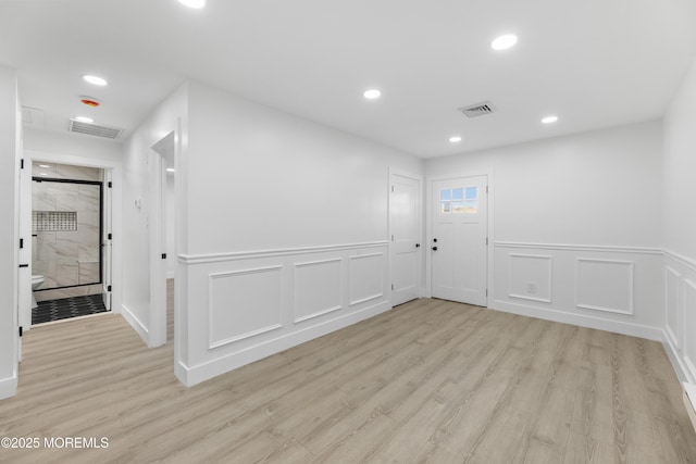 164 Cours De Clemenceau Unit E, Freehold, NJ 07728 - spare room featuring light wood-style floors, recessed lighting, a wainscoted wall, and a decorative wall