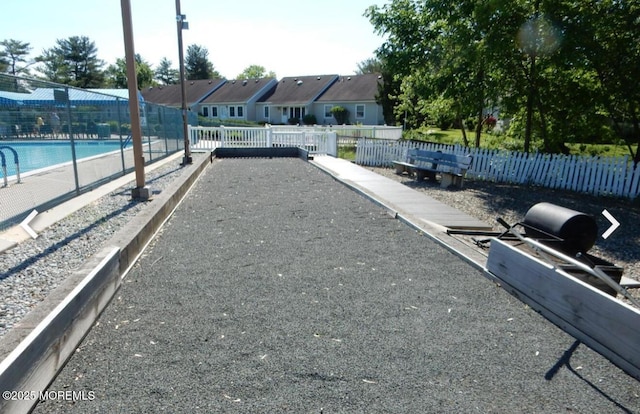 164 Cours De Clemenceau Unit E, Freehold, NJ 07728 - view of yard featuring a bocce ball area, a residential view, and a community pool