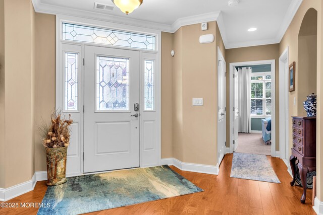 7 Bay Head Ct, Waretown, NJ 08758 - foyer with light wood finished floors, ornamental molding, and arched walkways
