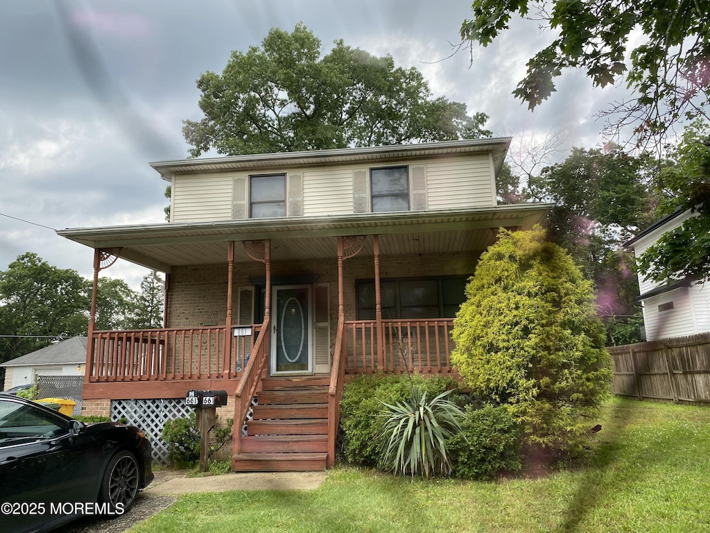 661 7th St, Lakewood, NJ 08701 - view of front facade featuring covered porch and brick siding