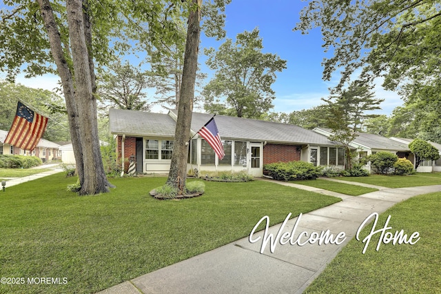 52A Cambridge Ct, Lakewood, NJ 08701 - view of front facade with brick siding, a front yard, and a shingled roof