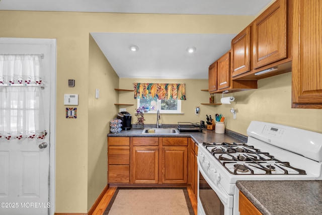 530 Aldrich Rd, Howell, NJ 07731 - kitchen with white gas range oven, dark countertops, brown cabinets, and recessed lighting