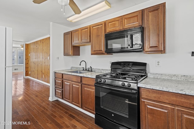118 Sampson Ave, Seaside Heights, NJ 08751 - kitchen featuring black appliances, a ceiling fan, dark wood-style floors, and brown cabinets