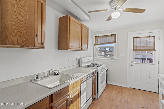 118 Sampson Ave, Seaside Heights, NJ 08751 - kitchen with white appliances, light wood-style flooring, ceiling fan, light countertops, and brown cabinets